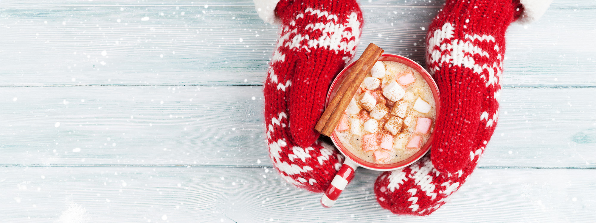 Holiday table spread with snowman cookies, hot chocolate and presents