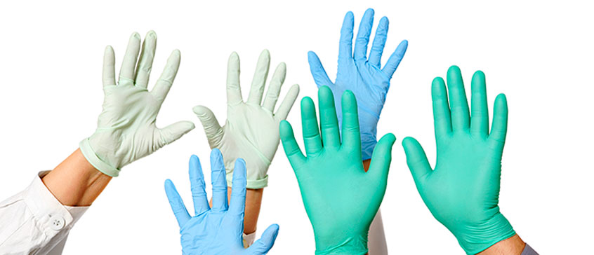 Photo of hands in the air wearing medical gloves. 