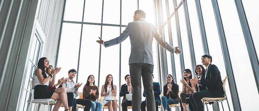 Photo of person giving presentation with a captivated audience.