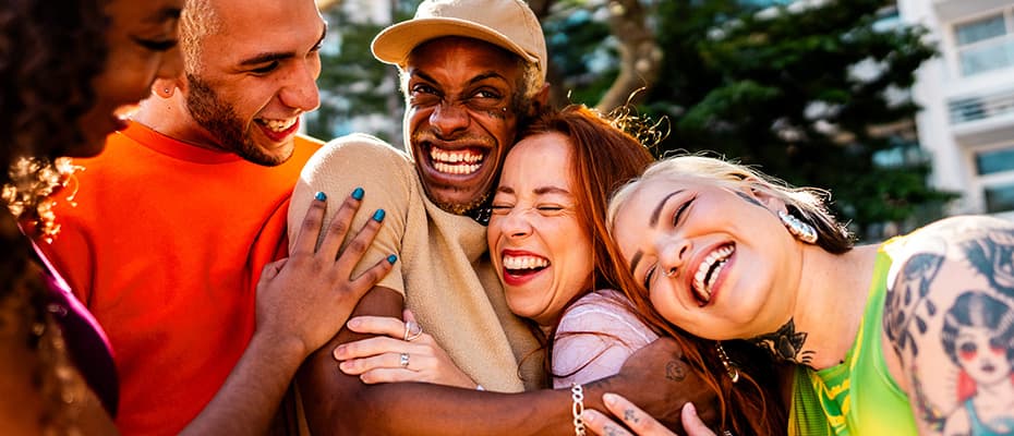 LGBTQIA+ friends embracing and talking outdoors