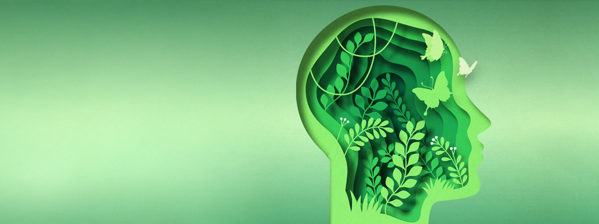 A green-toned illustration featuring the silhouette of a human head filled with layered foliage, plants, and butterflies