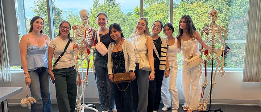 Participants pose with anatomy models during a visit to the University of Victoria