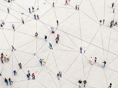 A group of people walking around in different directions.