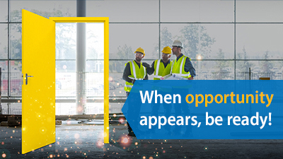 Yellow door opening to three people in hardhats with clipboards
