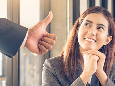 Women receiving a thumbs up.