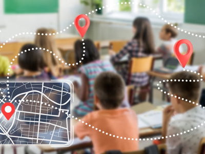 A blurred photo of children actively learning in a classroom. Overlaid a tablet showing navigation icons to symbolize navigating the wide needs of literacy in the classroom