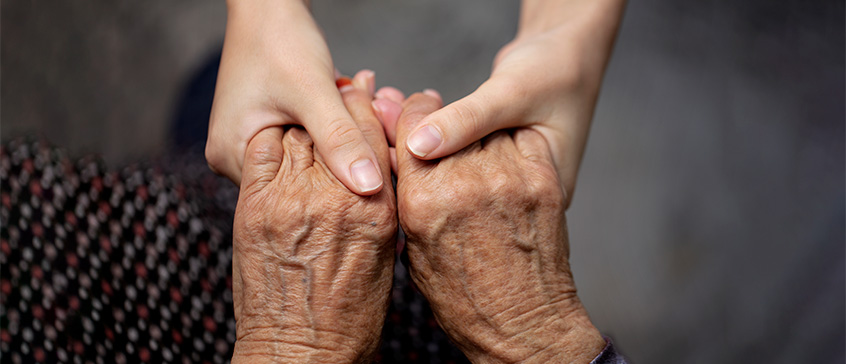 Closeup of young hands holding old hands