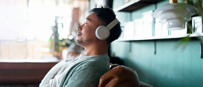 Man listening to music with a smile on his face.