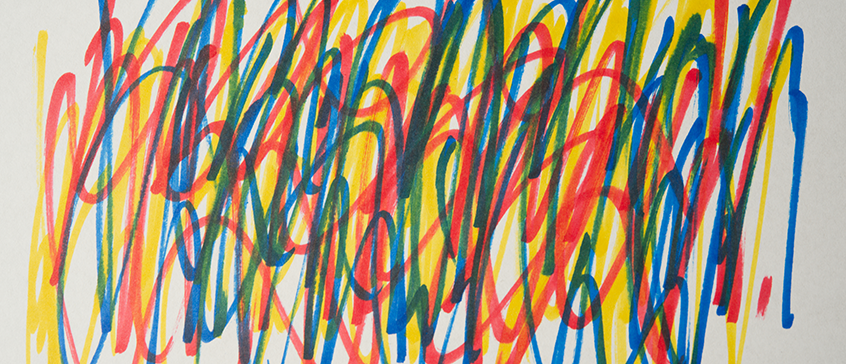 Energetic overlapping scribbles in red, yellow, and blue marker on a white background, with loose, vertical strokes that convey playful experimentation with colour and line