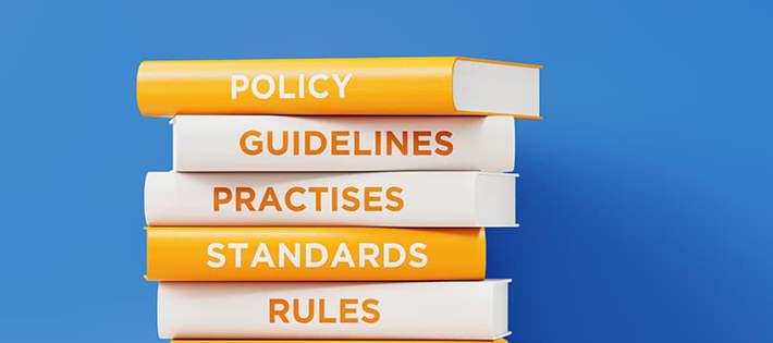 Stacked books showing Policy, Guidelines, Practices, Standards, and rules as titles on their spines.