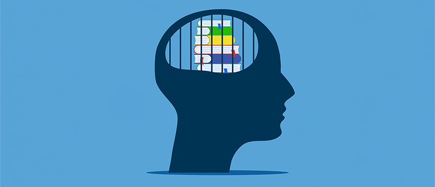 An illustration of books caged inside of the silhouette of a head. 