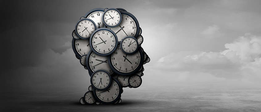 A silhouette of a head made of clocks with varying times is set against a gradient gray sky. Darker on the left, lighter on the right, it visually represents time's passage and shifting emotional states, relevant to the concept of grief.
