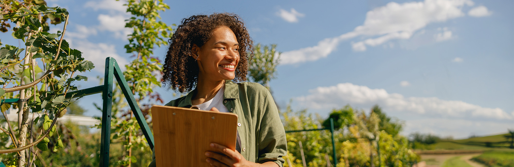 Woman with clipboard outside in nature