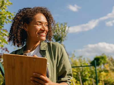 Woman with clipboard outside in nature