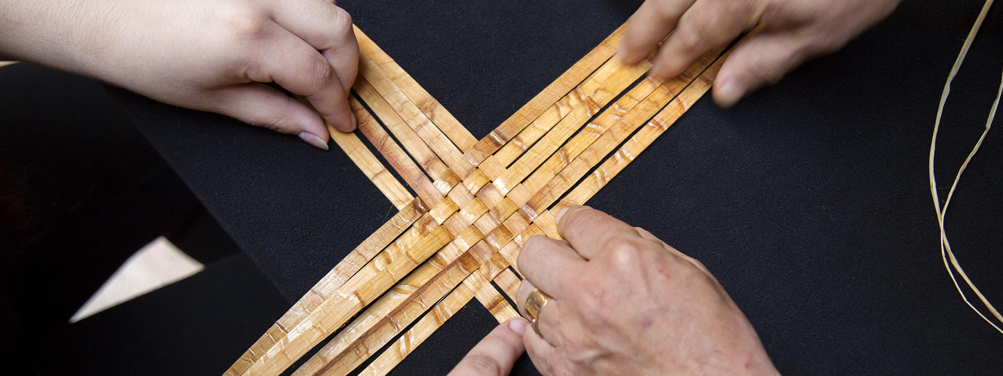 hands weaving basket
