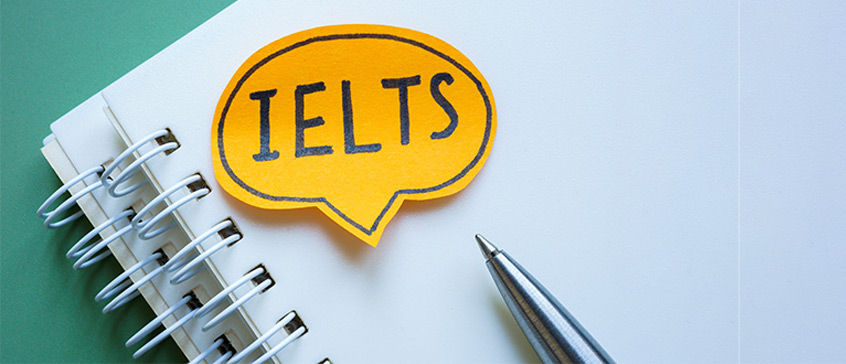 The word IELTS on a post-it note