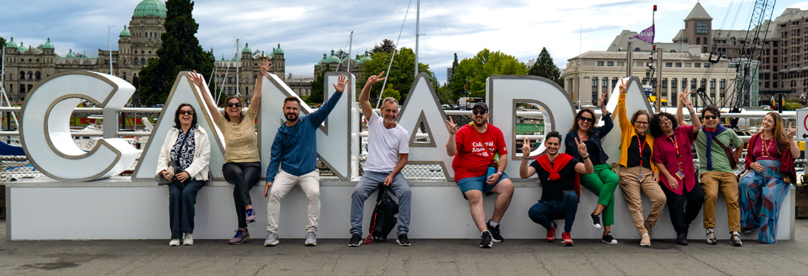 EMI students posing infront of the Canada letters at Victoria