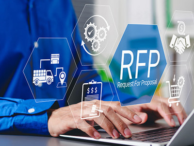 Person typing on a laptop with overlay icons representing contract bidding and procurement, including a truck, handshake, shopping cart, and "RFP Request For Proposal" symbol.