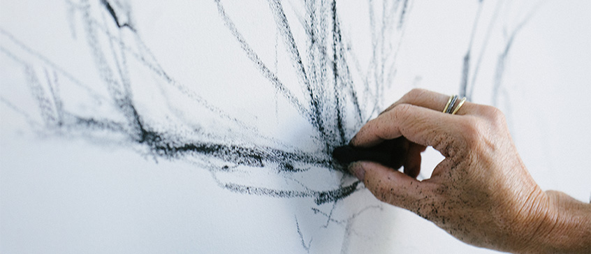 Closeup of hand drawing with charcoal. 