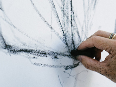 Closeup of hand drawing with charcoal. 