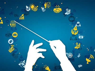 White silhouette of hands conducting with a baton against a dark blue background filled with floating communication and marketing icons including charts, email symbols, social media elements, and business graphics
