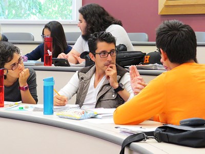 Students discussing course materials in a classroom