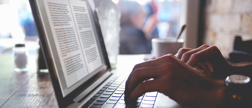 Closeup of hands typing at a laptop