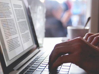 Closeup of hands typing at a laptop