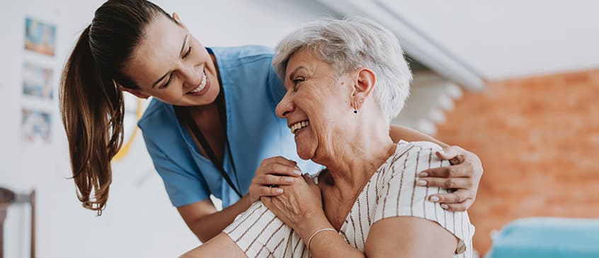 A nurse practitioner attends to an elderly patient