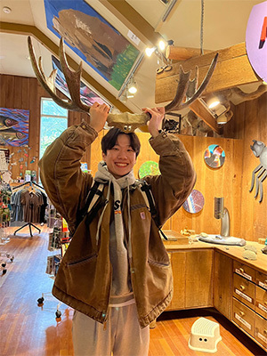 Student holding up moose antlers