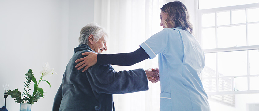 Healthcare worker tends to elderly patient