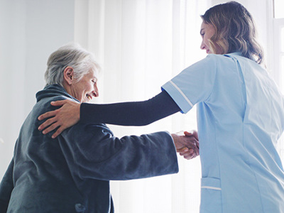 Healthcare worker tends to elderly patient