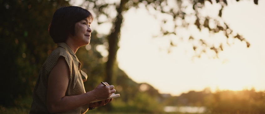 Woman outdoors gazing into distance