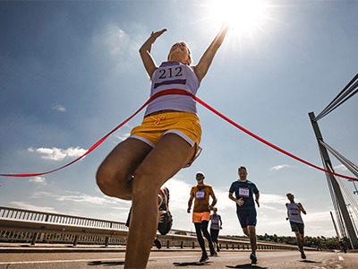 Athlete running through the finish line