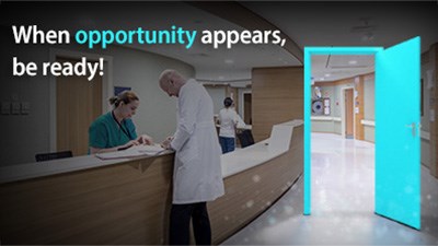 A doctor and nurse consult over a counter. An open door showing a clean, bright hospital.Overlaid text says, 'When opportunity appears, be ready.'