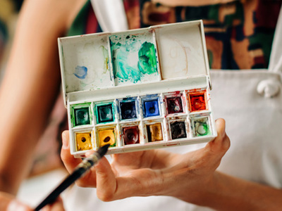 Woman holding watecolour pallet box