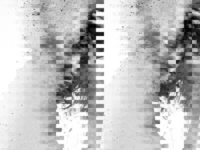 Black and white double exposure of a person clutching their head, with their face looking down and obscured by a dissolving, granular texture.