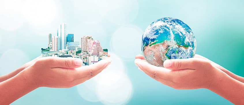 Hands holding a large city on the left with hands holding the earth on the right.