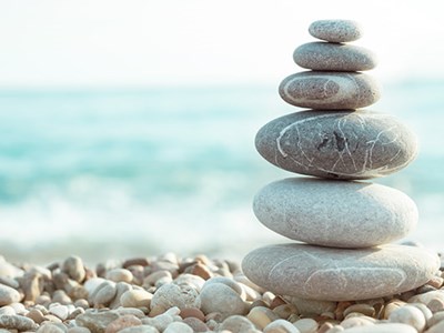 Smooth rocks stacked into a tower on a beach