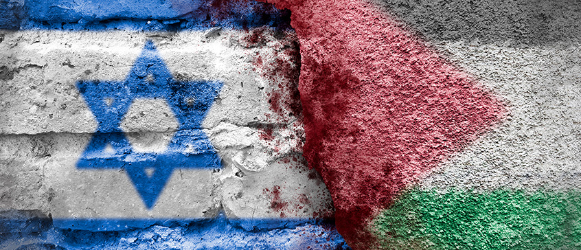 Israeli and Palestinian flags on a brick wall