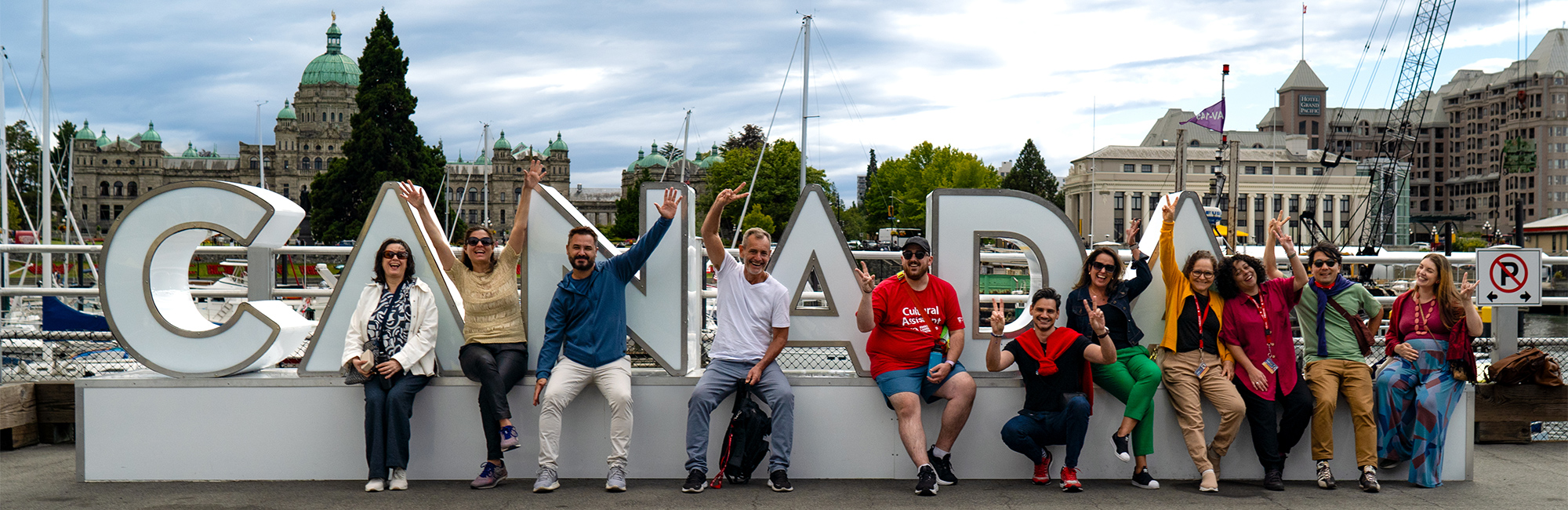 Students in front of a large CANADA sign in downtown Victoria, BC. 
