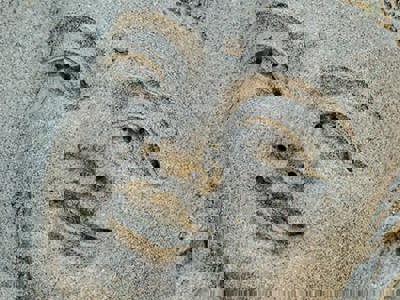 Bas-relief of a smiling face of Buddha gazing upwards