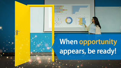 Open yellow door with woman looking at data charts in background.