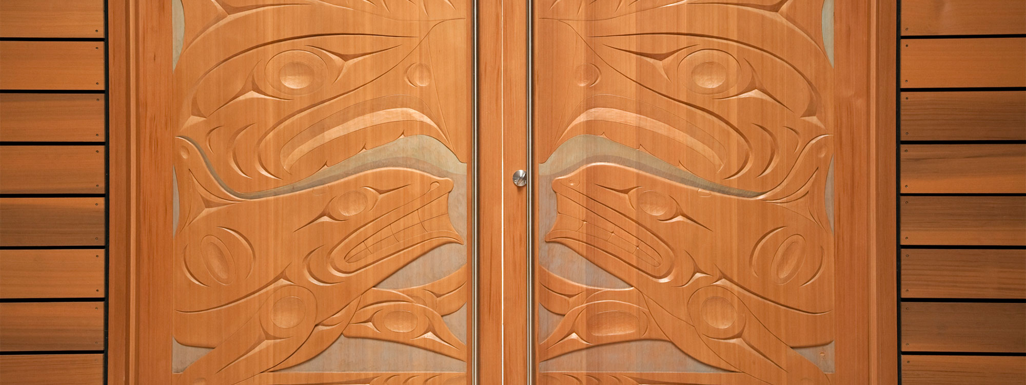 The First Peoples House at the University of Victoria. Pictured: Xwa Lack Tun's (Rick Harry) carved doors to the Ceremonial Hall.