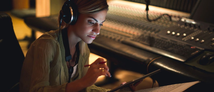 Woman in recording studio making notes