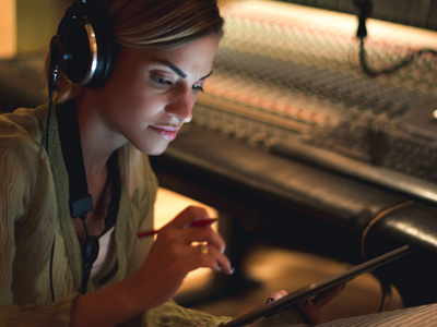 Woman in recording studio making notes