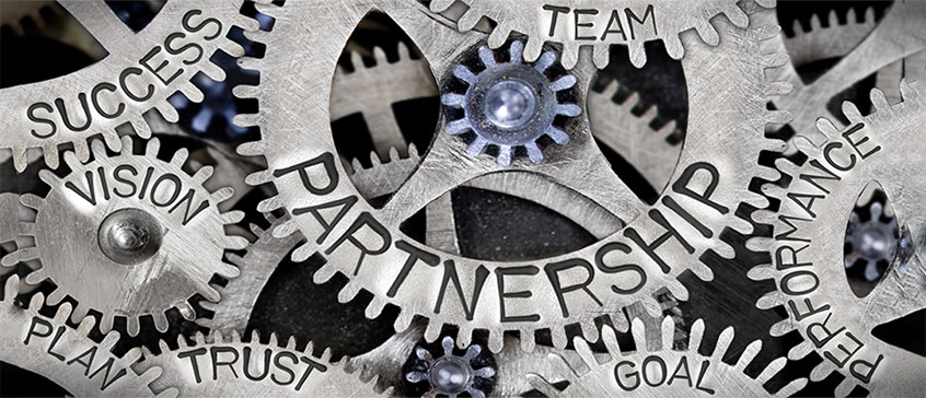 Image of cogs with the word partnership on them. 