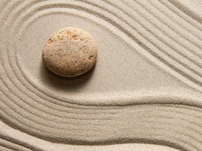 Top view of oriental raked sand with stones