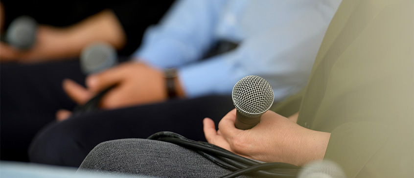 Closeup of hands holding microphones. 