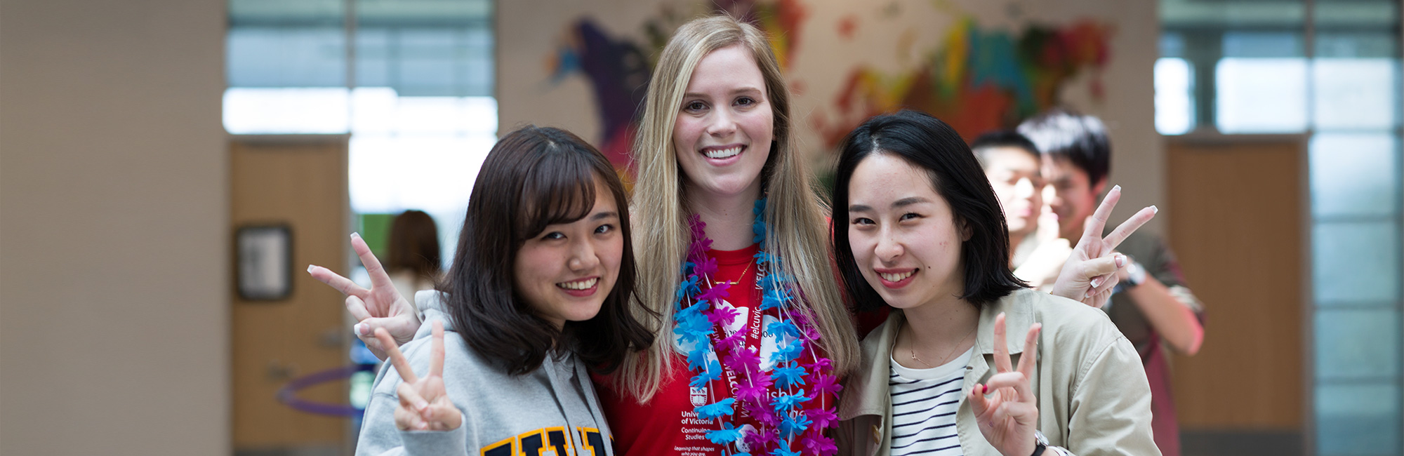 A cultural assistant with two ELC students having fun. 